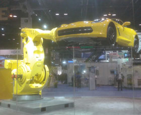 Photo of Fanuc robot moving a Corvette at the 2016 IMTS Show